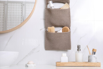 Countertop and storage with essentials in bathroom. Stylish accessory