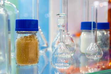 Medical glass bottles in showcase at pharmaceutical exhibition, pharmacy laboratory - close up. Pharma industry, science, medicine, experiment and healthcare concept