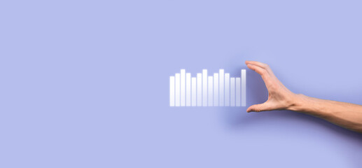 Male hand holding smart mobile phone with graph icon.checking analyzing sales data growth graph chart and stock market on global networking. Business strategy, planning and digital marketing