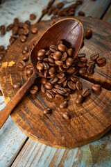 Coffee beans with wooden kitchen accessories on a rustic background