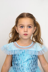 Adorable little girl in blue princess dress looking at camera on white background in studio 3 three years old photo for passport or ID card