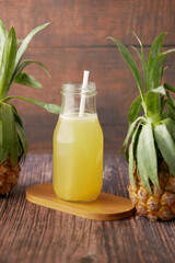pineapple juice in a bottle on table 