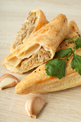 Golden samsa with ingredients on wooden background