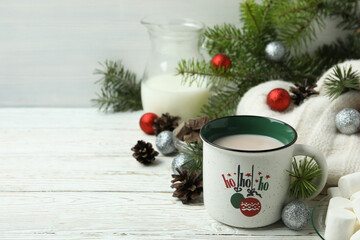 Concept of tasty drink with cocoa on white wooden table