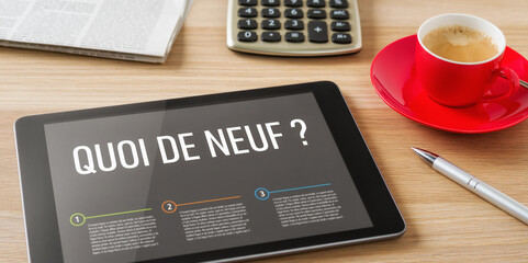 A tablet on a wooden desk - Whats new in french - Quoi de neuf
