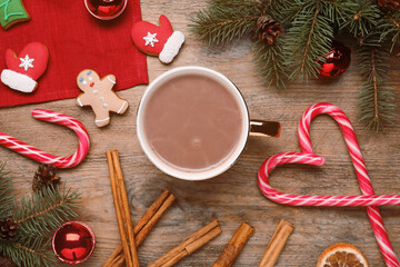 Flat lay composition with delicious hot chocolate and Christmas decor on wooden table