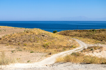 plains with steppe vegetation and lake view.