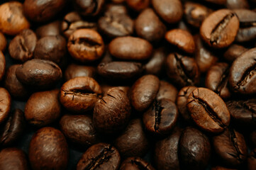 fresh roasted coffee beans as a background. a lot of coffee beans. macro photo of coffee beans