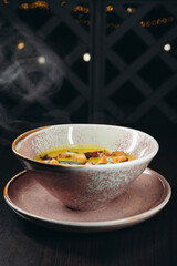 Tasty pumpkin cream soup with prawns and croutons.