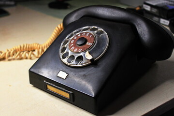 very old black phone with dial