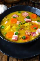 Hearty rustic pea soup with bacon and sausage