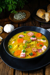 Hearty rustic pea soup with bacon and sausage