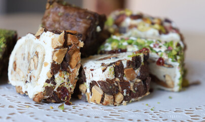 traditional Turkish sweets, baklava, lies on a beautiful napkin on the table. Treats, delicacies,...