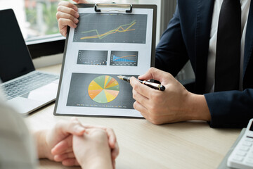 Two business leaders talk about charts, financial graphs showing results are analyzing and calculating planning strategies, business success building processes