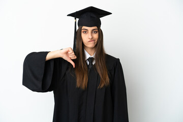 Young university graduate isolated on white background showing thumb down with negative expression
