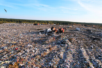Landfill waste disposal. Garbage dump with waste plastic and polyethylene. Garbage truck unloads rubbish in landfill. Reduce greenhouse gas emissions and methane emissions. Environmental protection.
