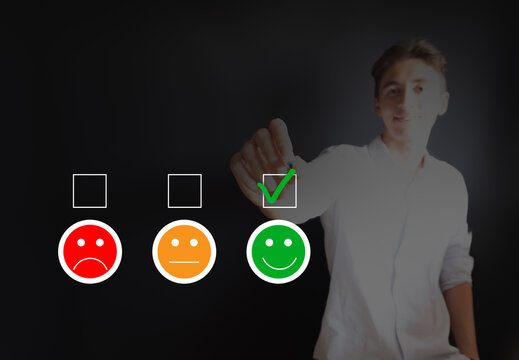 Young man marking happy mood on customer satisfaction survey form