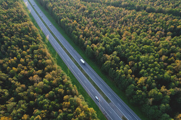 Car and truck driving on the highway, Top view. Trucks and cars in a traffic jam on rod. Cars and rush hours. Aerial view of a freeway traffic with truck semi trailer. Lorry driver delivers the cargo.