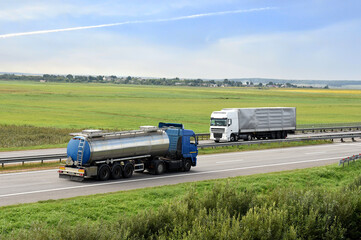 Isothermal Tank truck driving on highway. Oil and Gas Transportation and Logistics. Metal chrome cistern tanker with petrochemicals. Liquid Chemical Freight and foodstuff.