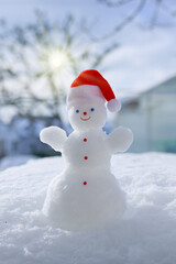 Happy snowman stand in white snow. Winter christmas landscape.