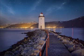 Foto op Canvas Starry night over Høgstein lighthouse on Godøy, Norway © Hennie