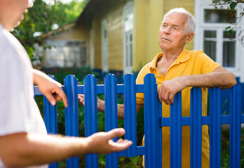 Old man talking with his neighbour