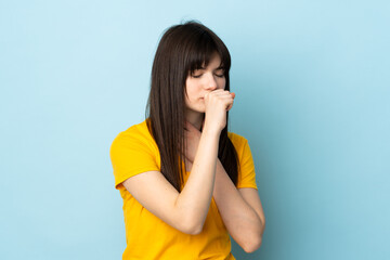 Teenager Ukrainian girl isolated on blue background coughing a lot