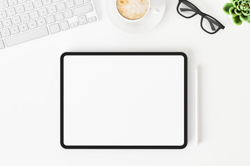 Top view of blank screen tablet on white working desk