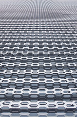 industrial grid wall metallic construction perspective surface with holes soft focus vertical background close up picture concept