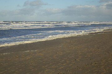 Rolling North Sea waves at the beach on a sunny stormy winter morning, Egmond aan Zee, North Holland, Netherlands
