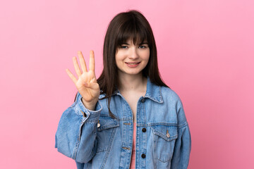 Young Ukrainian woman isolated on pink background happy and counting four with fingers