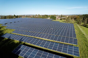 Solar energy farm. High angle, elevated view of solar panels energy farm rural England; full frame background texture .
