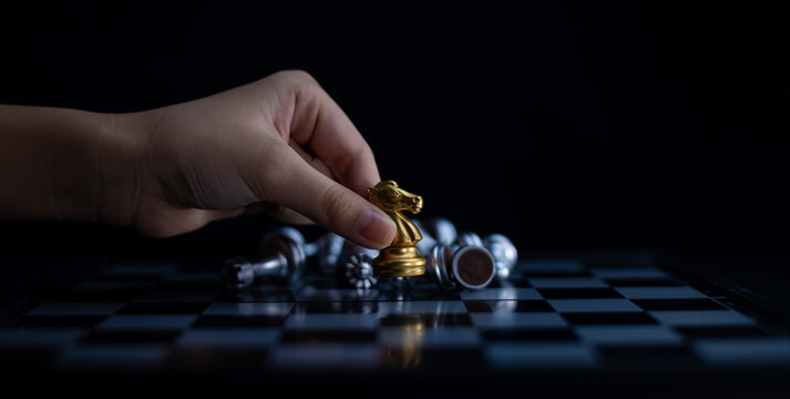 Chess board game knight gold team is winner silver team stategy game as business challange competitive game ,this business stategy plan concept.