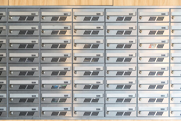 Modern metal mailboxes with lock and numbering as background