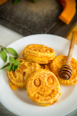sweet lush pumpkin pancakes with honey in a plate