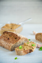 homemade liver pate with bread on a wooden table