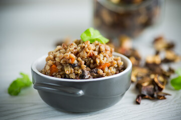 boiled buckwheat with vegetables and dried forest mushrooms in a ceramic mold