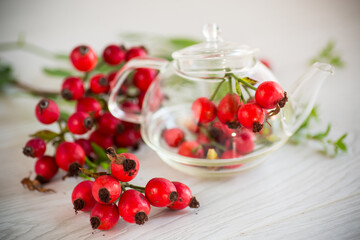 ripe red rose hips on a wooden table
