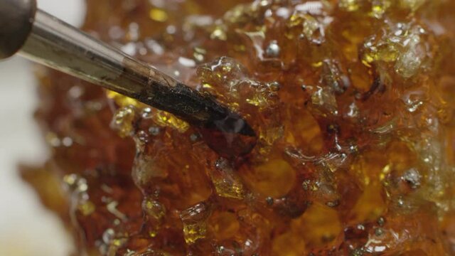 A soldering iron is lowered into rosin