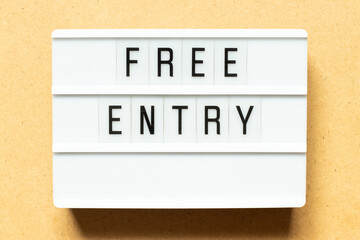 Lightbox with word free entry on wood background
