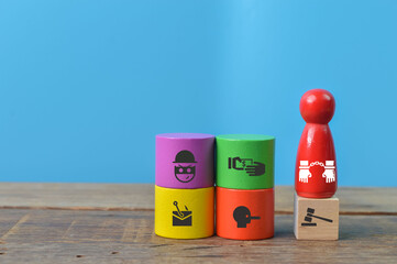 Wooden people figure with corruption and anti-money laundering symbols