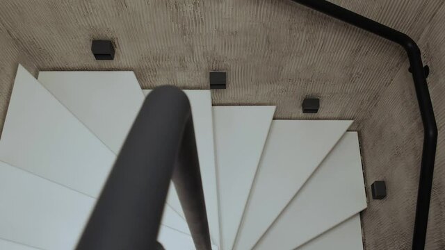 Interior photography. White spiral staircase with metal railings in a duplex apartment.