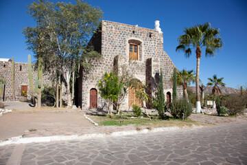 Fototapeta na wymiar beautiful catholic church, beautiful in the desert, on the road, cactus on the road, south america, mexico, california 