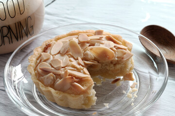 Almond tarts with hot latte on the table