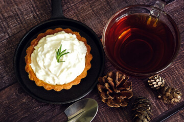 Apple tart with hot tea on wooden table