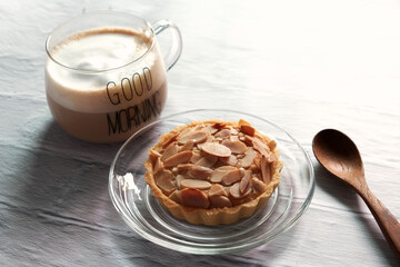 Almond tarts with hot latte on the table