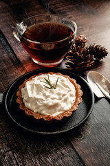 Apple tart with hot tea on wooden table