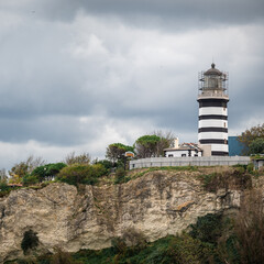 Fototapeta na wymiar Lighthouse On The Rocks near Sile, Istanbul, Turkey, Black Sea. Lighthouse on rock near sea. Ocean coast with rocks and lighthouse