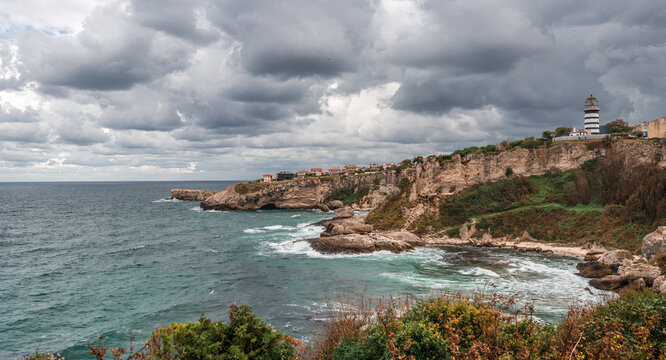 View of lighthouse at seashore against cloudy sky. Beautiful Lighthouse On The Rocks near Sile, Istanbul, Turkey, Black Sea. panorama