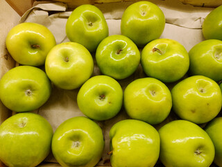 Fresh green apples in the counter shop in supermarket